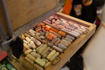 High angle view of chalks in wooden container