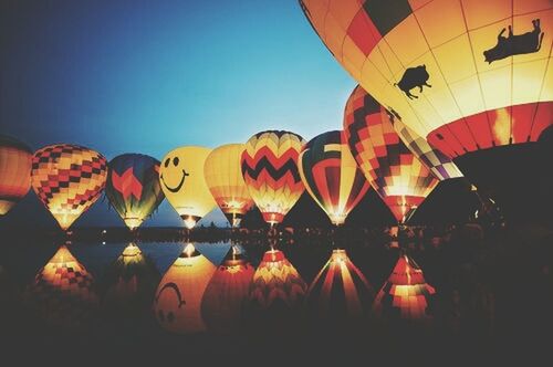 clear sky, illuminated, low angle view, multi colored, red, built structure, architecture, lantern, copy space, lighting equipment, hanging, yellow, orange color, chinese lantern, decoration, in a row, outdoors, building exterior, hot air balloon, no people