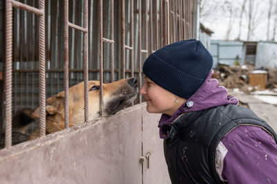 Girl volunteer in the nursery for dogs. shelter for stray dogs.