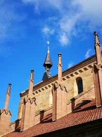 Low angle view of bell tower against blue sky