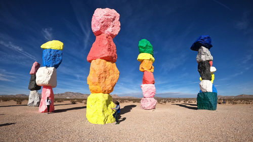 Colorful rocks arranged against sky