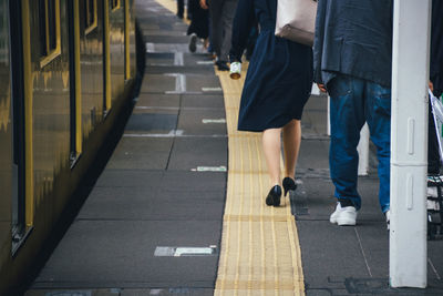 Low section of people walking on railway bridge