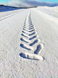 Tire tracks on snow covered land