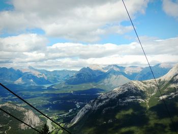 Scenic view of mountains against cloudy sky