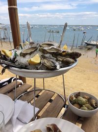 Mussels in container on table at beach