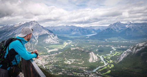 Hiker enjoying view on beautiful alpine valley with mountains and river, banff national park, canada