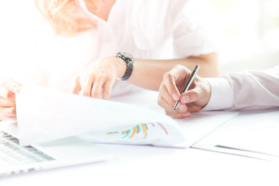 Midsection of woman working on table