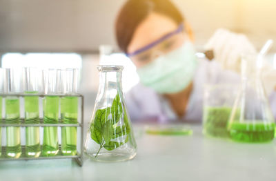 Close-up of female scientist experimenting in laboratory