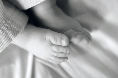 Low section of child on bed at home