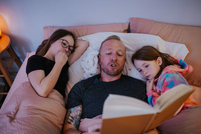 Overhead of dad reading to children