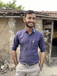 Portrait of young man standing outdoors