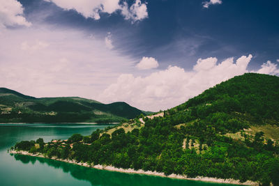 Scenic view of lake and mountains against sky