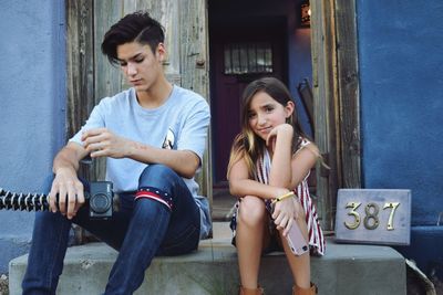 Portrait of siblings on doorstep