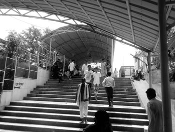 Rear view of people walking on staircase