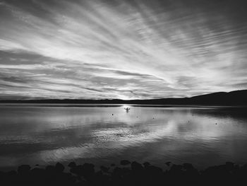 Scenic view of lake against sky at sunset