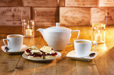 Coffee cup and tea cups on table