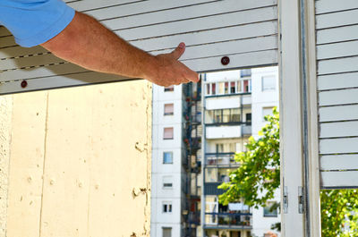 Man hand on building in city