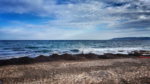 Scenic view of sea against cloudy sky