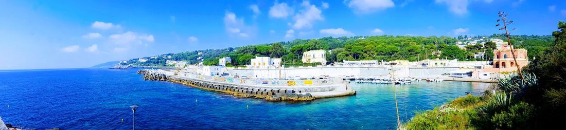 Panoramic view of bay against blue sky