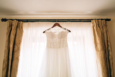 Close-up of clothes hanging on white wall