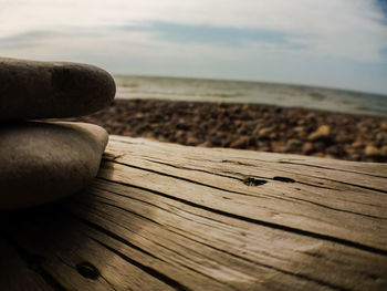 Close-up of wood on beach against sky