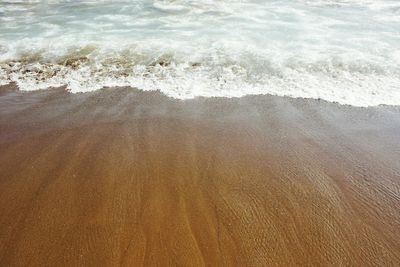 High angle view of waves rushing towards shore