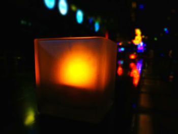 Close-up of lit candles on table