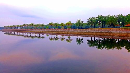 Scenic view of lake against sky at sunset