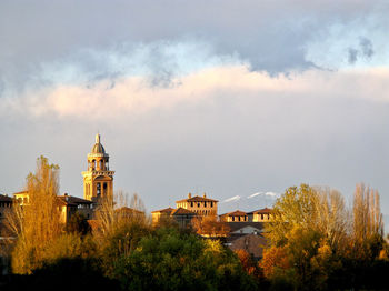 Panoramic view of trees and buildings against sky