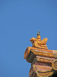 Head of roof charms is man on phoenix in the forbidden city, beijing 