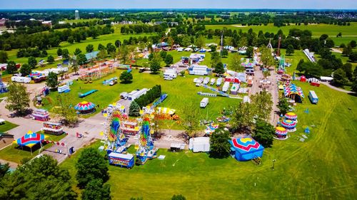 High angle view of trees and buildings on field