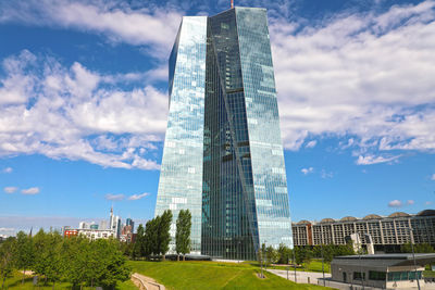 Low angle view of buildings against cloudy sky