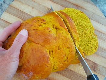 Close-up of hand holding bread on table