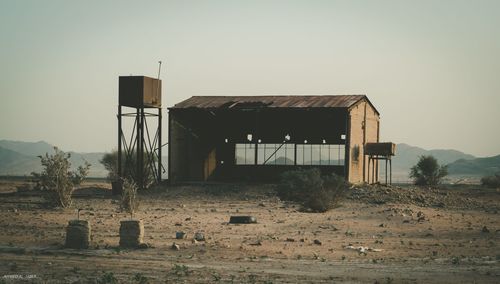 Old building on field against clear sky