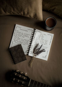 Cropped hand of woman holding book on table