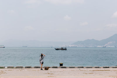 Man standing on beach against sky