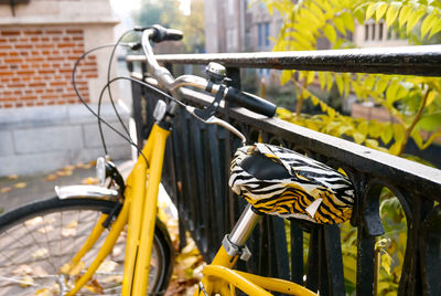 Close-up of bicycle parked against wall