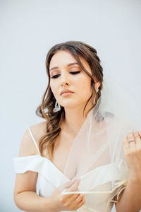 Portrait of a beautiful young woman over white background