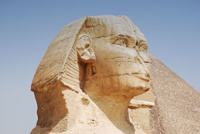 Low angle view of statue against sky