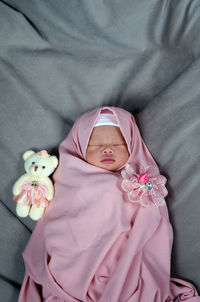 High angle view of cute baby on bed