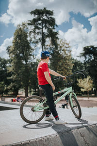 Man riding bicycle against sky