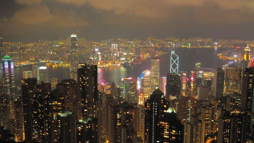 Illuminated cityscape against sky at night