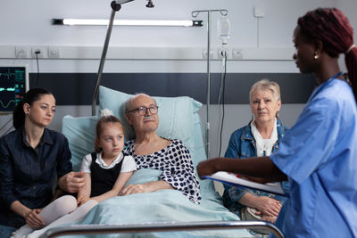 Side view of doctor examining patient at clinic