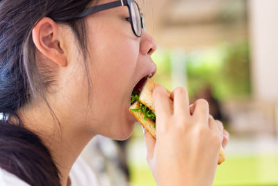 Close-up portrait of woman eating food