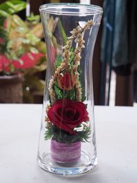 Close-up of rose bouquet in glass on table