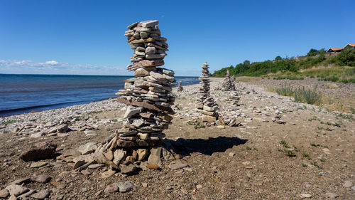 Stack of rocks on beach against sky