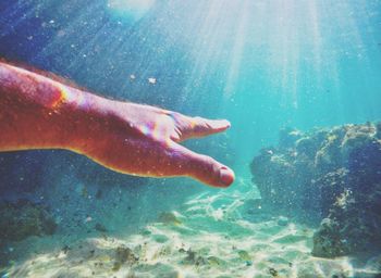 Close-up of hand swimming in sea