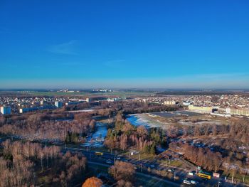 High angle view of cityscape against blue sky