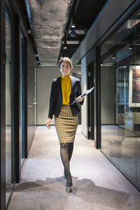 Businesswoman walking through corridor