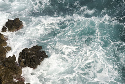 High angle view of rocks in sea